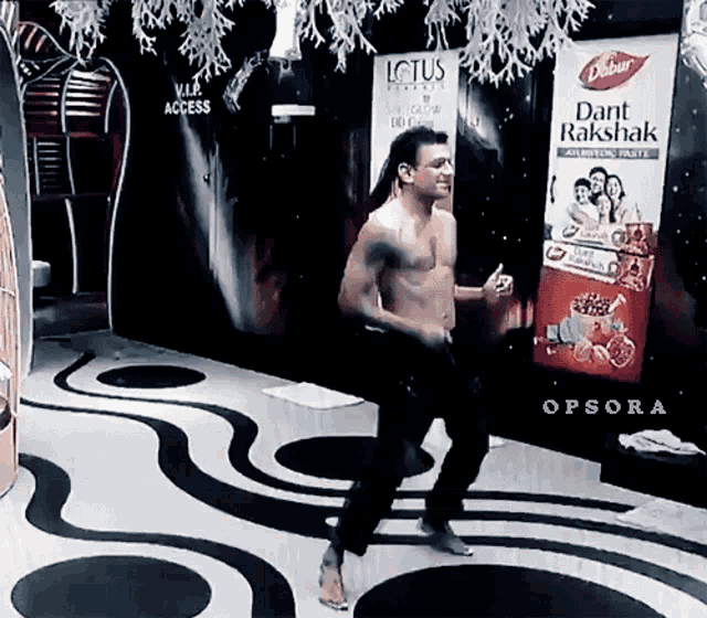 a man without a shirt is dancing in front of an opsora advertisement