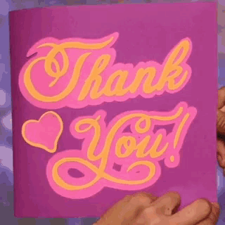 a person is holding a purple card that says " thank you "