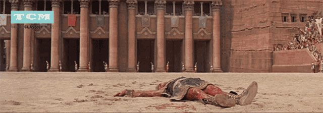 a poster for tcm shows a gladiator laying in the sand