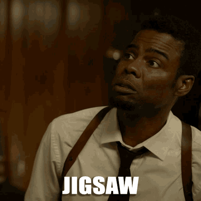 a man wearing suspenders and a tie with the word jigsaw behind him