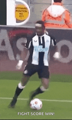 a soccer player is kicking a soccer ball on a field with the words fight score win below him