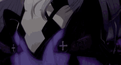a close up of a person wearing a purple shirt with a cross on it