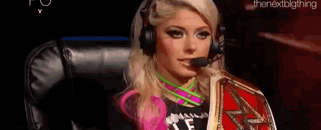 a woman wearing headphones is sitting in a chair with a microphone .