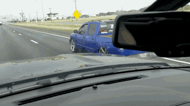 a blue truck with a sticker on the back that says t on it