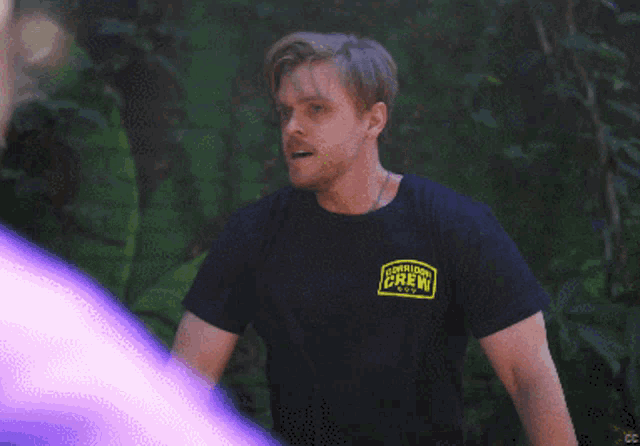 a man wearing a black t-shirt that says expedition crew
