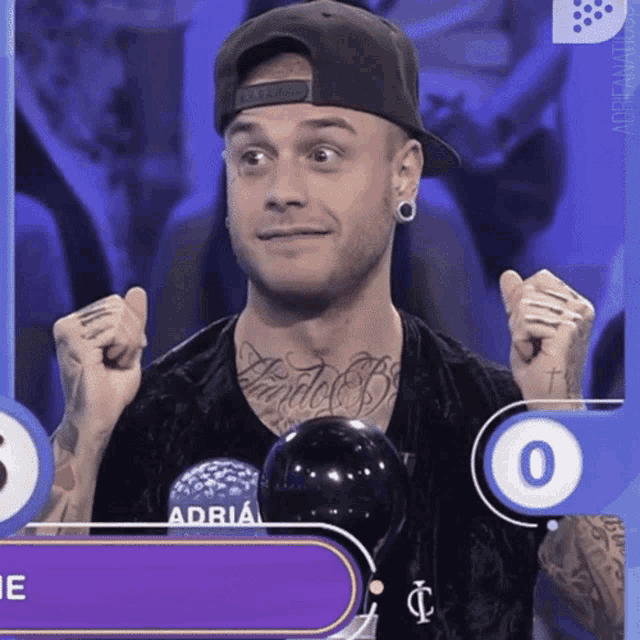 a man with a tattoo on his chest is wearing a hat and a shirt that says adria