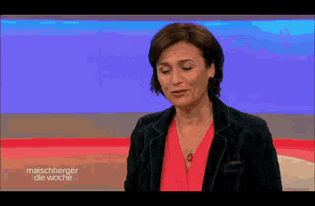 a woman is laughing on a tv show called maischberger die wache