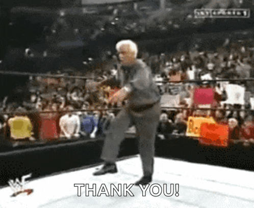 an older man is standing on a wrestling ring and says thank you