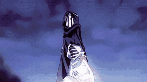 a person with a hood on their head is standing in front of a blue sky .