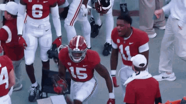 a football player with the number 15 on his jersey is kneeling down