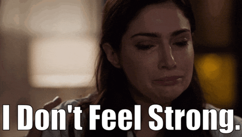 a woman is crying with the words " i don 't feel strong " behind her