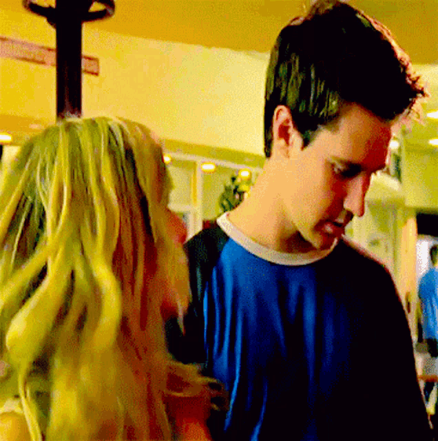 a man and a woman are standing next to each other