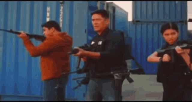 a man holding a gun next to a police officer with the word police on his shirt