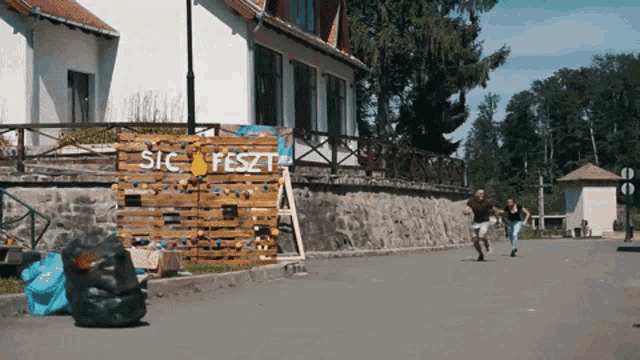people running in front of a sign that says sic fest on it