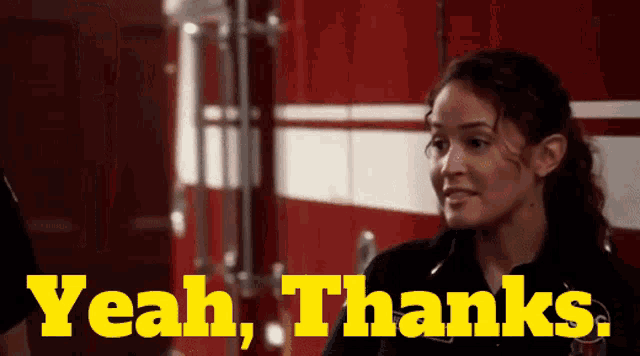 a woman says yeah thanks in front of a red and white truck