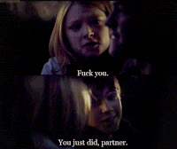 a man and a woman are looking at each other and the woman says " fuck you "