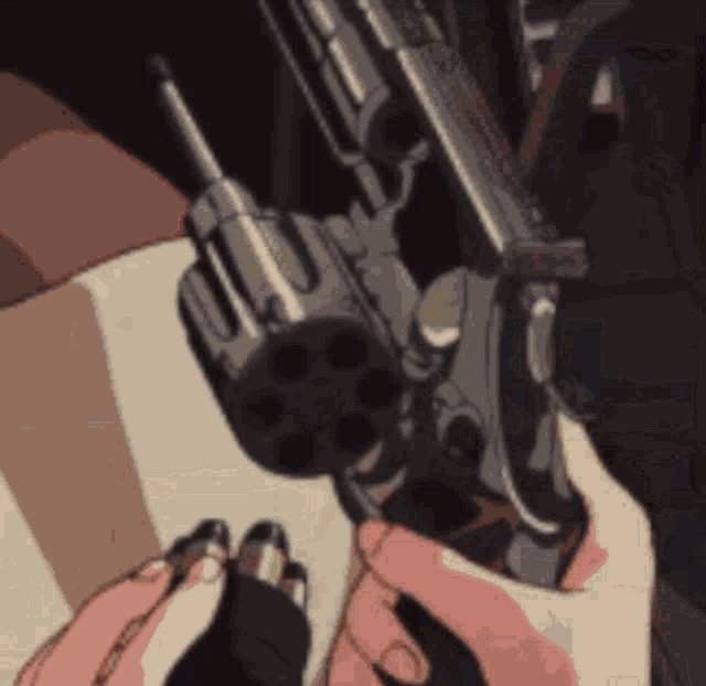 a close up of a person holding a gun in their hand