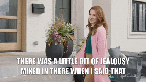 a woman in a pink cardigan says there was a little bit of jealousy mixed in there when she said that