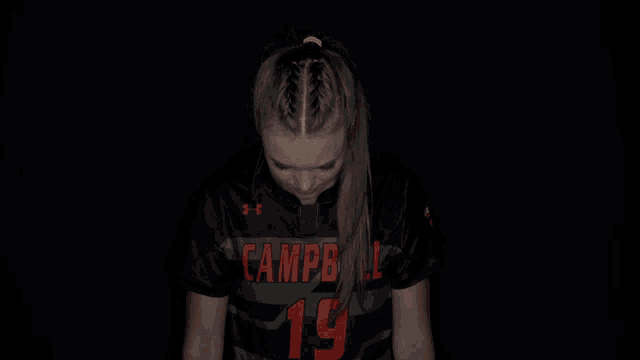 a girl wearing a black shirt that says campbell on it