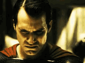 a close up of a man in a superman costume with a serious look on his face