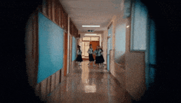 a hallway in a school with a sign that says exit