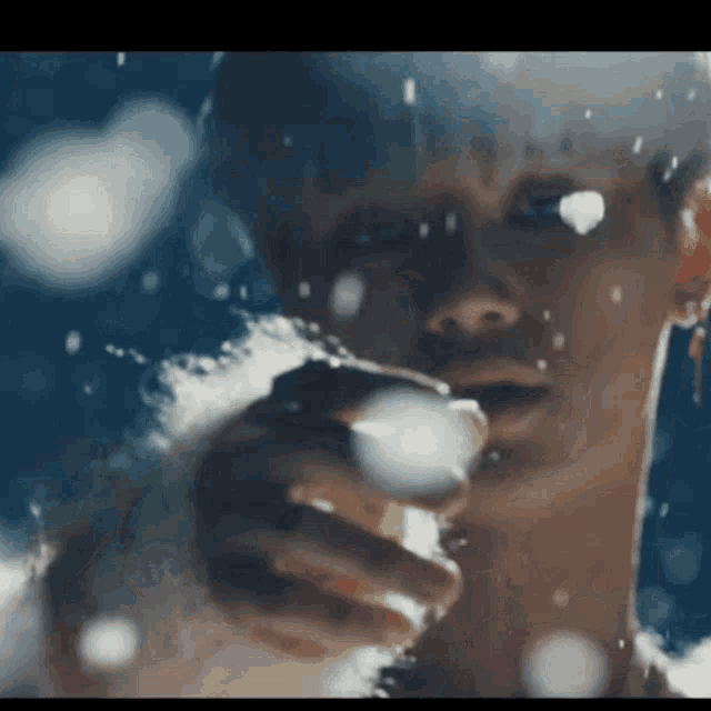 a close up of a woman 's face with water coming out of her mouth