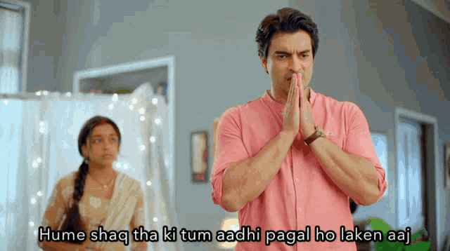 a man in a pink shirt is praying in front of a woman with the caption hume shaq tha ki tum aadhi pagal ho laken