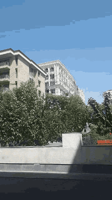 a large building with a lot of windows is surrounded by trees