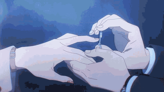 a man is putting a wedding ring on a woman 's finger