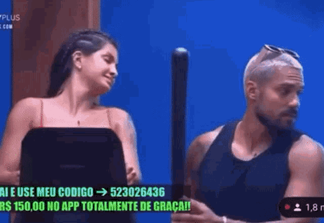a man and a woman are standing next to each other on a television screen .