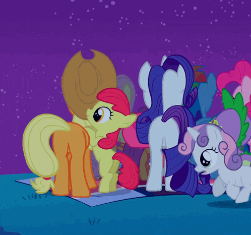 a bunch of ponies are standing on a purple surface