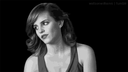 a black and white photo of a woman making a funny face with her eyes closed .