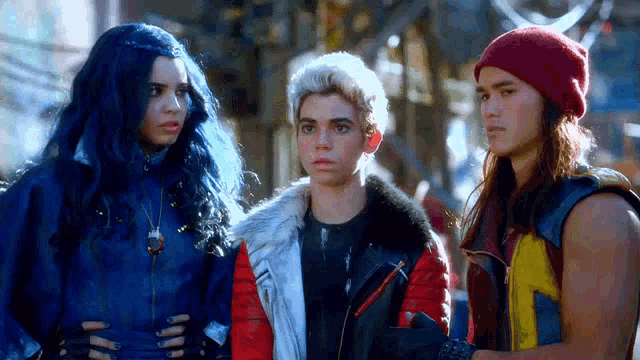 a group of three people are standing next to each other .