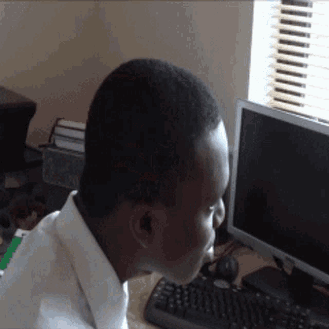 a man sits in front of a dell computer monitor
