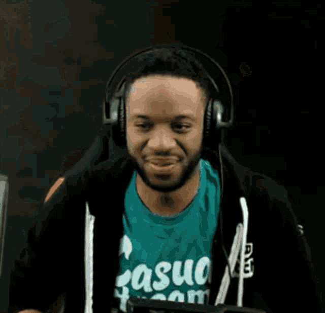 a man wearing headphones is wearing a casual team shirt