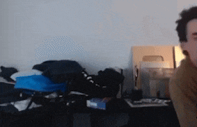 a blurry picture of a man sitting in a room