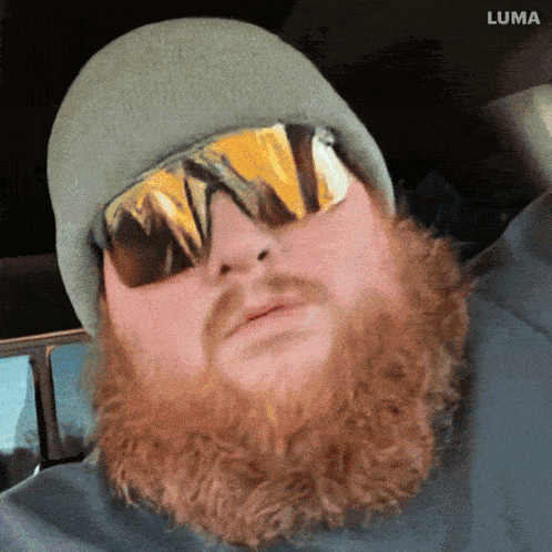 a man with a beard wearing sunglasses and a beanie with luma written on the bottom right