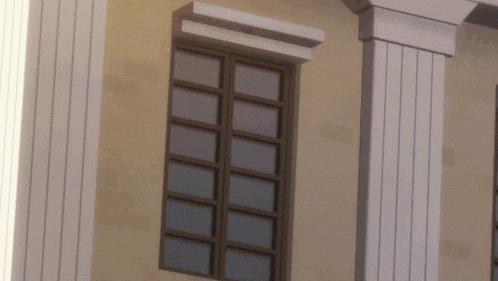 a building with columns and a window with a brown frame