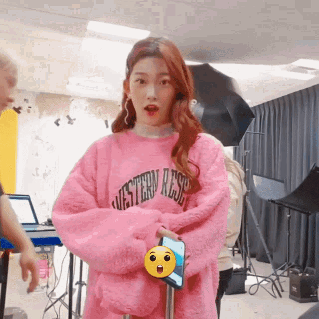 a woman wearing a pink sweater that says western rese
