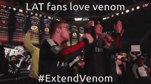 a group of people standing in front of a screen that says lat fans love venom #extendvenom