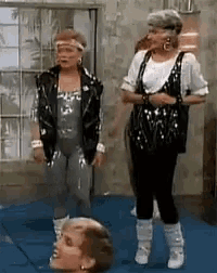 a group of women are standing next to each other on a blue mat .