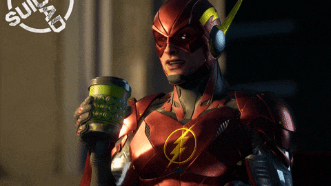 a man in a flash costume is holding a green cup