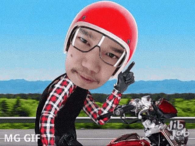 a man wearing a red helmet and glasses is riding a motorcycle