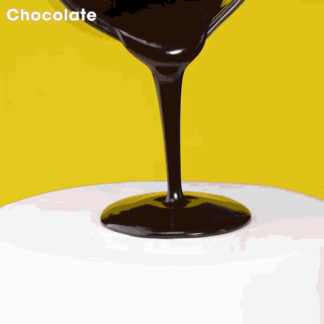 chocolate is being poured into a white cake