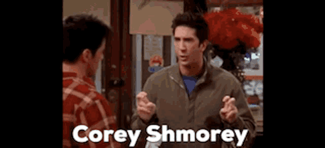 two men are standing next to each other and one of them is named corey shmorey