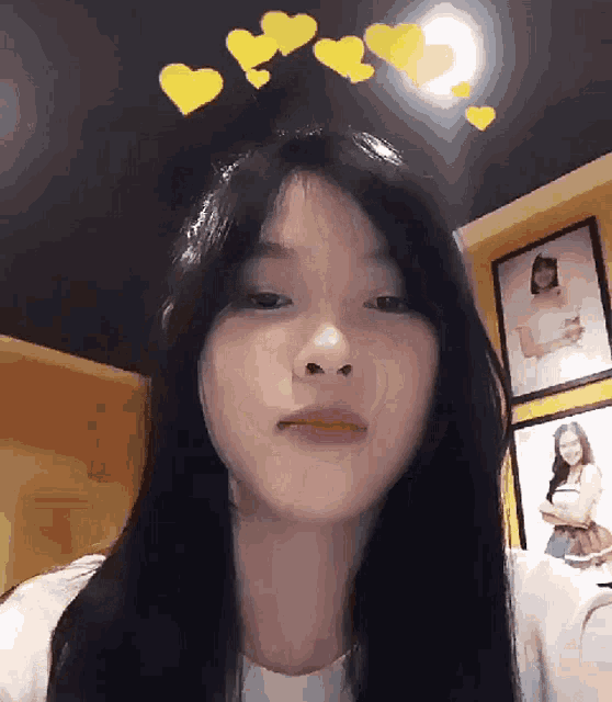 a girl with long black hair has hearts on her head