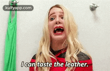 a woman with blonde hair is making a funny face and saying `` i can taste the leather '' .