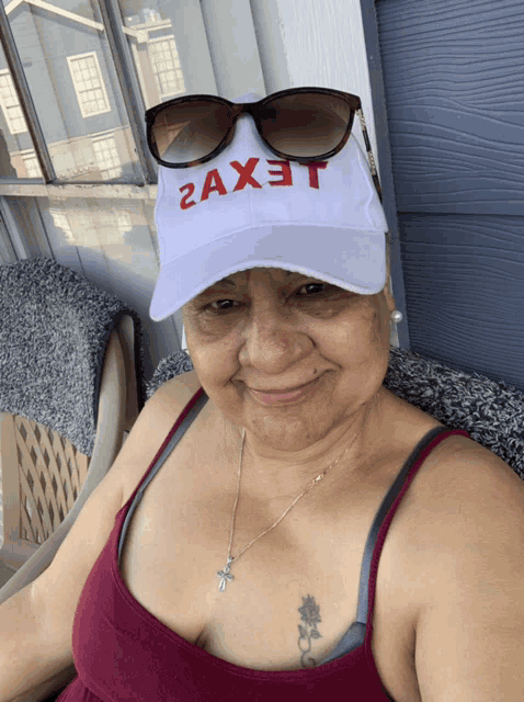 a woman wearing a white hat that says 2ax3t on it