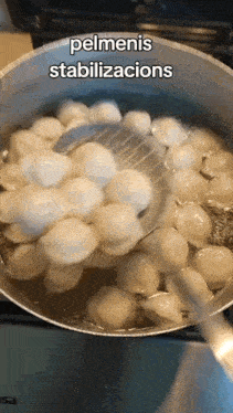 a pot of pelmeni is being stirred with a spoon and the words pelmenis stabilizacions are above it