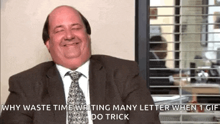 a bald man in a suit and tie is smiling and laughing while sitting in front of a window .